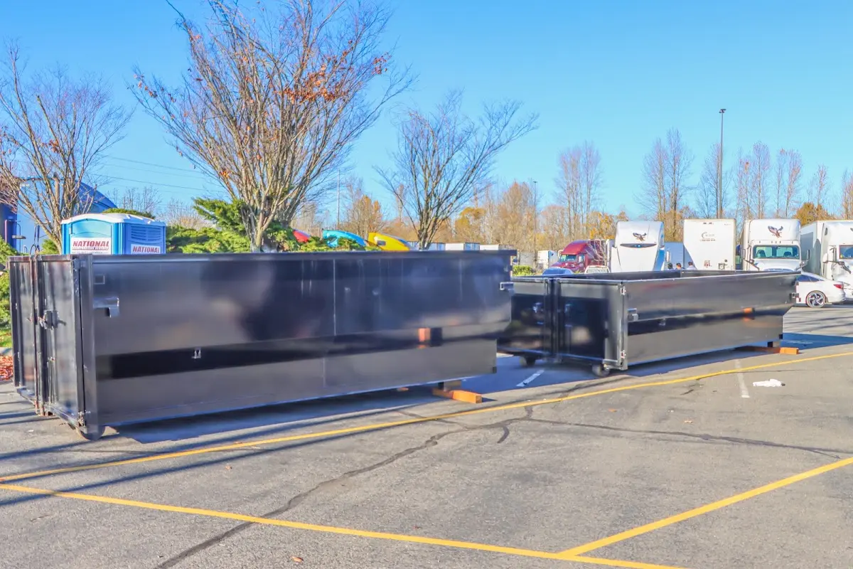 Professional dumpster rental service with roll-off container on residential driveway in Trussville